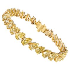 This beautiful tennis bracelet features 28 perfectly matched Pear Shaped yellow Diamonds set at an angle for a very elegant and sophisticated look. Measure 6.5 inches. Set in 18 Karat Yellow Gold. Luxury Dazzling Yellow Gold Diamond Bracelet, Elegant Luxury Yellow Gold Diamond Bracelet, Yellow Diamond Tennis Bracelet, Yellow Diamonds, Yellow Jewelry, Diamond Tennis Bracelet, Tennis Bracelet Diamond, Pear Shaped Diamond, All That Glitters