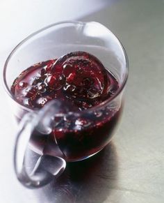 a glass filled with liquid sitting on top of a table