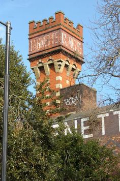 an old brick tower with graffiti on it