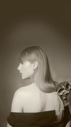 a black and white photo of a woman with long hair wearing a bow in her hair