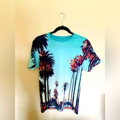 Brand New W/ Tags. River Island Men's T-Shirt Palm Tree Graphic Print Los Angeles Logo Print Crew Neck Short Sleeve 95% Polyester, 5% Elastane Cool Iron Machine Wash At Max 40c Gentle Do Not Bleach Do Not Tumble Dry Do Not Dry Clean Casual Cotton Tops With Palm Tree Print, Casual Cotton Top With Palm Tree Print, Casual Crew Neck Top With Palm Tree Print, Relaxed Fit Palm Tree Print Short Sleeve Tops, Palm Tree Print Relaxed Fit Short Sleeve Tops, Cotton Crew Neck Top With Palm Tree Print, Relaxed Fit Short Sleeve Top With Palm Tree Print, Relaxed Cotton Top With Palm Tree Print, Palm Tree Print Graphic Tee With Crew Neck