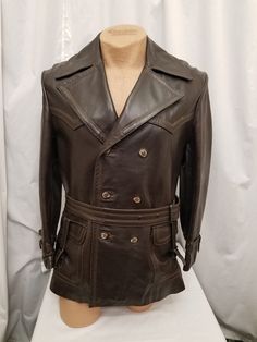 Amazing Rare Vintage 1950's Field & Stream Vented Brown Leather Trench Coat Jacket w Plaid Wool Lining Rancher Biker.  Coat has a 3  button front closure, a notched collar, a back vent,  a matching belt, 2 large front pockets, stitching details, and a removeable plaid wool warm lining.  See the super cool buckle details on the sleeve cuffs and the front pockets!  Coat is in amazingly Excellent condition.  See pics! Coat Measurements when buttoned:  Shoulder to shoulder 19, neck to bottom hem 31, Designer Fitted Outerwear With Belt Loops, Designer Fitted Leather Jacket With Belt Loops, Formal Fitted Belted Leather Jacket, Vintage Double-breasted Leather Jacket For Fall, Classic Fitted Biker Jacket With Buttons, Retro Brown Double-breasted Outerwear, Vintage Double-breasted Outerwear, Vintage Long Sleeve Biker Jacket With Button Closure, Fitted Vintage Brown Retro Leather Jacket