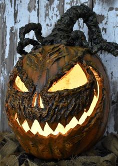 a carved pumpkin with an evil face on it