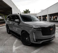 a grey suv parked in a parking lot