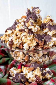 a glass bowl filled with chocolate covered popcorn