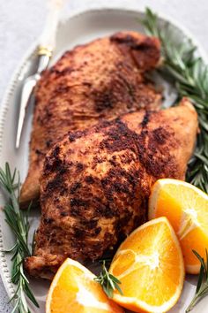 a white plate topped with meat and oranges