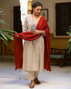 This is a stunning 3-piece set. It comes with a white hand block printed kurta with 3/4th sleeves and a v-neck. The set comes with a pair of printed semi elasticated ankle length palazzo pants and a contrast dupatta to match. Color- Cream & Red Work-Print Work Suit Fabric-Cotton Dupatta Fabric-Mulmul Neck-V Neck Work-Print work with lace detailing Length-Calf Length Care-Hand Wash or Dry Clean Monochrome Kurta Set, Contrast Dupatta, Red Kurti, Cream Suit, Dabu Print, Cotton Frocks, Kurta Pant Set, Pakistani Fashion Party Wear, Cotton Dupatta