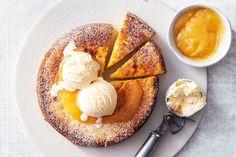 a piece of cake on a plate with ice cream and caramel sauce next to it