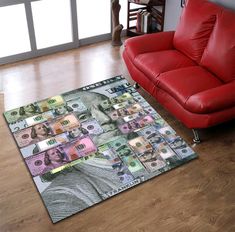 a living room with a red leather couch and rug on top of the wooden floor