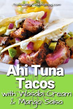 two tacos on a white plate with text overlay reading ahi tuna tacos with wasabi cream and mango salsa