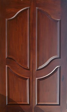 an open wooden door with decorative carvings on the front and side panels in dark wood