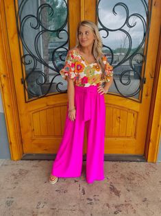 Elevate your style with our "She Stands Out" pants. These high-waisted palazzo pants offer both comfort and airflow, perfect for any occasion. The self-tie in the front and smocked back add a touch of elegance to these vibrant pink-colored pants. Feel confident and stand out in the crowd with our statement piece. Paired with our 'Petal Picking' Top Inseam: 30" Model is 5'1 and has on 3" block heels Chic Rayon Jumpsuits And Rompers For Spring, Summer Wide Leg Jumpsuits With Elastic Waistband, Summer Wide Leg Jumpsuits And Rompers With Elastic Waistband, Summer Wide-leg Jumpsuits And Rompers With Elastic Waistband, High Waist Rayon Wide Leg Pants For Summer, Vacation Wide Leg Jumpsuits With Elastic Waistband, Summer Ankle-length Wide Leg Pants With Tie Waist, Vacation Wide-leg Jumpsuits With Elastic Waistband, Pink High-waisted Wide Leg Pants For Vacation