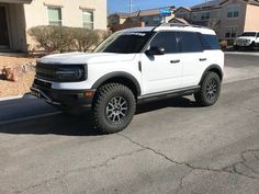 a white truck parked in front of a house