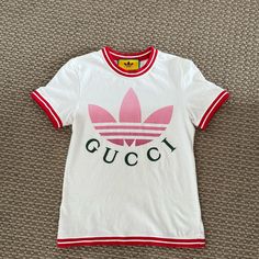 This Is An Authentic Gucci X Adidas Collaboration Tee. Worn Once Comes With Original Packaging Purchased Directly From Gucci White Sporty Gucci Top, Sporty White Gucci Tops, Summer Tops With Logo Detail, Gucci Fitted Casual Top, Casual Fitted Gucci Tops, Gucci White Crew Neck Top, White Gucci Crew Neck Top, Gucci Crew Neck Spring Tops, Gucci White Fitted Tops