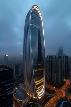 an aerial view of a very tall building in the middle of a city at night