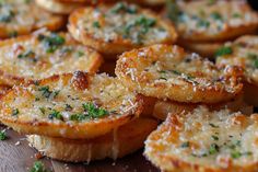 some food that is sitting on a wooden table with parmesan cheese and herbs