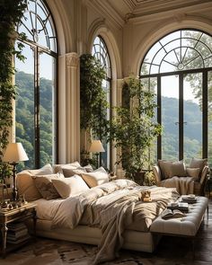 an elegant bedroom with large windows and lots of natural greenery on the walls, along with white bedding