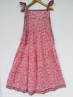 "Bohemian cotton pink printed long gown, block print maxi dress, cotton smocked dresses, strap outfits, cotton maxi, long maxi, dresses, hand block print dress, smocking dress, comfortable dresses, summer dresses, beautiful gift for her, indian dress seller, indian wholesaler, customized dress available, beautiful dress, shirred bodice dresses, summer dress, long maxi, pink maxi Feel beautiful and confident throughout your days wearing our block printed outfits, made with high quality soft and breathable cotton fabric.  The print on the dress is known as \"BLOCK PRINT\" which is centuries old technique of Indian textile carried out  by local artisans of Jaipur (INDIA) MEASUREMENTS (in inches): Size XXS-: Bust- 34″ | Shoulder- 13.5″ | Length- 51″ Size XS-: Bust- 36″ | Shoulder- 14″ | Length Sleeveless Cotton Maxi Dress With Block Print, Red Cotton Dress With Bandhani Print, Bohemian Maxi Dress With Bandhani Print, Bohemian Bandhani Print Maxi Dress, Bohemian Pink Cotton Sundress, Sleeveless Cotton Maxi Dress With Boho Print, Sleeveless Cotton Boho Print Maxi Dress, Red Cotton Maxi Dress With Block Print, Pink Cotton Maxi Dress