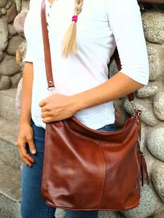 "Cognac Slouchy Tote Bag, Leather Purse, leather bag with zipper, Cognac Handbag for Women, Soft Leather Bag , Large leather Oversized bag The bag has a shoulder or hand strap. The bag can also be worn over the shoulder thanks to the adjustable strap. On the front of the bag there is a zippered pocket. A practical pocket on the back. The bag is stylized in the style of Boho Bag has a detachable tassel. The whole bag is fastened with a zipper. The bag has a lining, a phone pocket inside and a zip. The bag is medium in size. You can put cosmetics, books, magazines, an iPod and many other things in it. A simple classic purse you'll love! A leather wallet with a zipper is attached to the bag. Cognac bag made of high quality, soft Italian natural leather. Model Hobo Bag and crossbody bag will b Slouchy Tote Bag, Cognac Bag, Slouchy Hobo Bag, Slouchy Tote, Large Leather Bag, Large Leather Tote Bag, Soft Leather Bag, Handbag For Women, Large Leather Tote