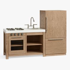 a wooden kitchen with an oven, sink and cupboards on the counter top next to a faucet