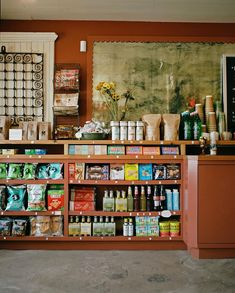 a store filled with lots of food and condiments on top of wooden shelves