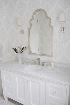 a bathroom with two sinks and a large mirror on the wall above it's counter