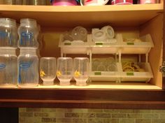 the shelves are filled with plastic cups and containers for drinking water, lemonade or other beverages