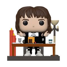 a pop vinyl figure sitting at a table