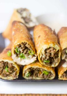 there are some meat and cheese rolls on the plate, ready to be eaten for lunch