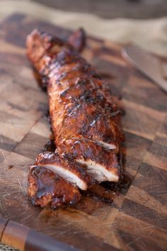 a piece of meat sitting on top of a wooden cutting board