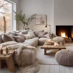 a living room filled with furniture and a fire place in the middle of the room