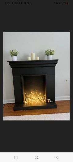 a black fireplace with some candles on it