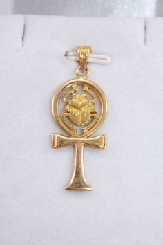 "Egyptian Handmade Ankh Cross Key Of Life + Scarab 18K Yellow Gold Pendant 4 Gr Weight Approximate : 4 Gr Height : 1.1\" = 34 mm Width : 0.5\" = 14 mm ✔ IT IS Tested & SIGNED WITH THE EGYPTIAN Gold Government HALLMARK FOR 18K GOLD to Ensure Authenticity. ✔ Lovely gift idea ABSOLUTELY GORGEOUS, LOOKS FABULOUS ON. ✔ 100% Egyptian handmade. ✔ Condition: A brand-new, exactly as on the photos. ★ GIFTS ✔ All items are packaged in a paper jewelry gift box, ready for gifting. ✔ If you are sending a gift Antique Gold Ankh Jewelry, Antique Ankh Jewelry As Gift, Antique Ankh Jewelry Gift, Antique Ankh Shaped Jewelry Gift, Egyptian Gold, Egyptian Revival Jewelry, Key Of Life, Ankh Cross, Paper Jewelry