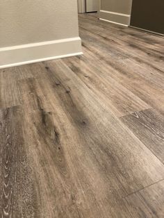 the inside of a house with wood flooring and white trim on the door way