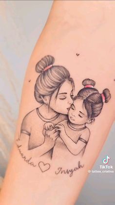 a mother and daughter tattoo on the arm