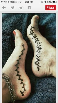 two people with tattoos on their feet