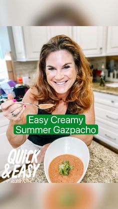 a woman holding a spoon over a bowl of soup with the words easy creamy summer gazpacho