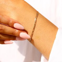 Our 14K Yellow Gold Figaro bracelet is made with genuine 14K solid gold to last you a lifetime. The perfect gold bracelet to add to your stack. Gold KT: 14K Solid Gold Gold Color: Yellow Gold Bracelet Lengths: 6.5", 7", 7.5" Bracelet Width: 3 mm Chain Style: Figaro Chain Classic Hypoallergenic Chain Bangle Bracelet, Classic Hypoallergenic Bangle Chain Bracelet, Gold Plated Curb Chain Bracelets, Classic Adjustable Figaro Chain Bracelets, Yellow Gold Plated Figaro Chain Bracelet, Dainty Gold Plated Bracelet With Figaro Chain, Dainty Gold-plated Bracelet With Figaro Chain, Hypoallergenic Yellow Gold Bangle Chain Bracelet, Adjustable Yellow Gold Bracelet With Figaro Chain