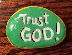 a cookie with the words trust god painted on it