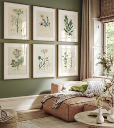 a living room filled with furniture and paintings on the wall above it's windows