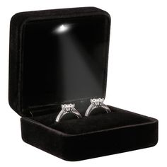 two diamond engagement rings in a velvet box