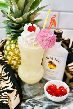 a pineapple drink with whipped cream and cherries