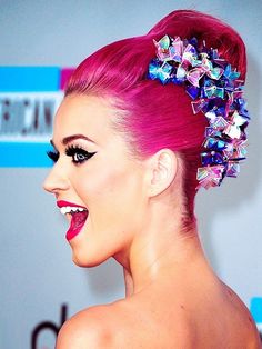 lady with pink hair and flowers in her hair at an awards event wearing a white strapless dress