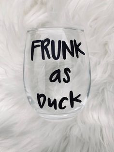 a wine glass that has the words frunk as duck written in black on it