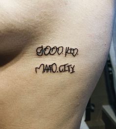 a tattoo that says good, bad and maq city on the side of a man's stomach