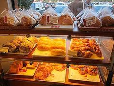 a display case filled with lots of different types of doughnuts and pastries