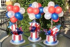 red, white and blue party hats on top of each other with balloons in them