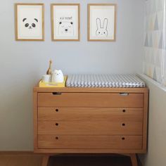 a baby crib with two pictures on the wall