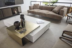 a living room filled with furniture and a flat screen tv on top of a wooden table