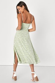 For the ultimate chic choice, choose the Lulus X LUSH Timeless Touch Green Floral Print A-Line Midi Dress! Light and breezy, green and white ditsy floral print woven fabric adds retro appeal to this classic sundress with adjustable skinny straps, a ruffle-trimmed neckline, and a button-front bodice with a ruched, set-in waist. A-line midi skirt finishes off this closet essential. Hidden back zipper/clasp. Fit: This garment fits true to size. Length: Mid-calf length. Size medium measures 42.5" fr Spring Green A-line Midi Dress, Green A-line Midi Dress For Spring, Green Printed Midi Dress For Garden Party, Garden Party Green Printed Midi Dress, Green A-line Midi Dress With Floral Print, Green Printed Midi Sundress, Chic Green V-neck Floral Dress, Spring Green Printed Midi Dress, Green A-line Floral Dress For Summer